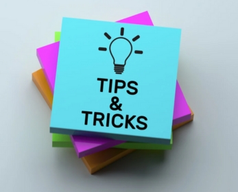 The words study tips and tricks written on a Post-it Notes stack.