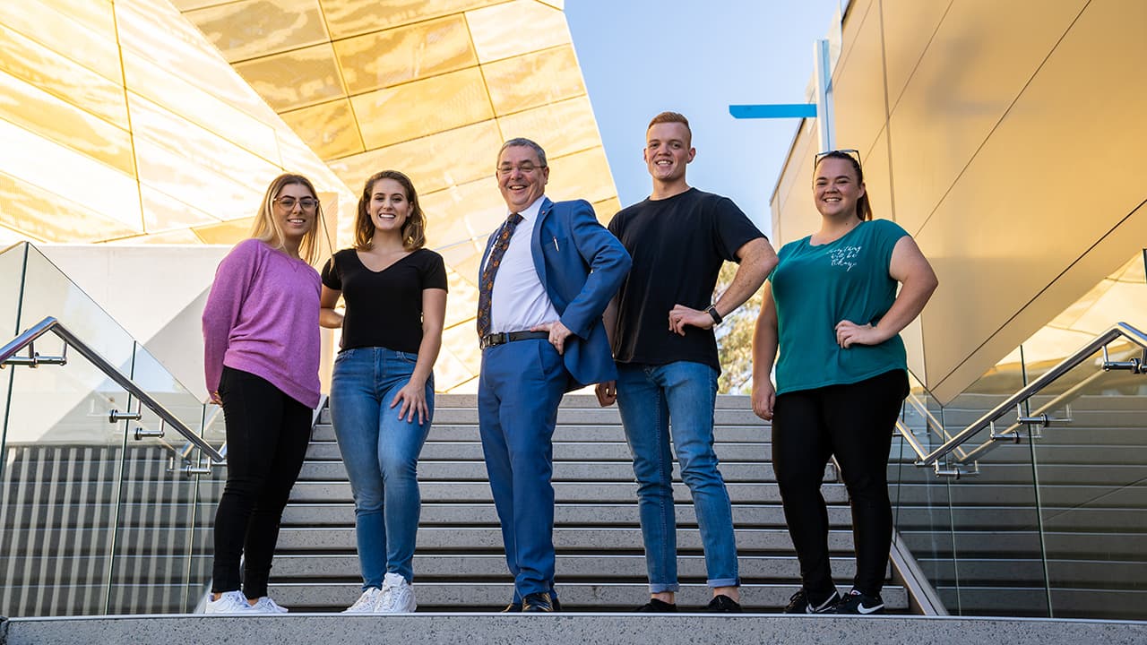 Students standing on steps 