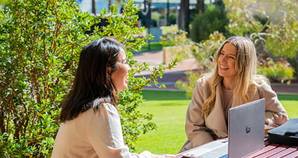 Students sitting and talking on campus