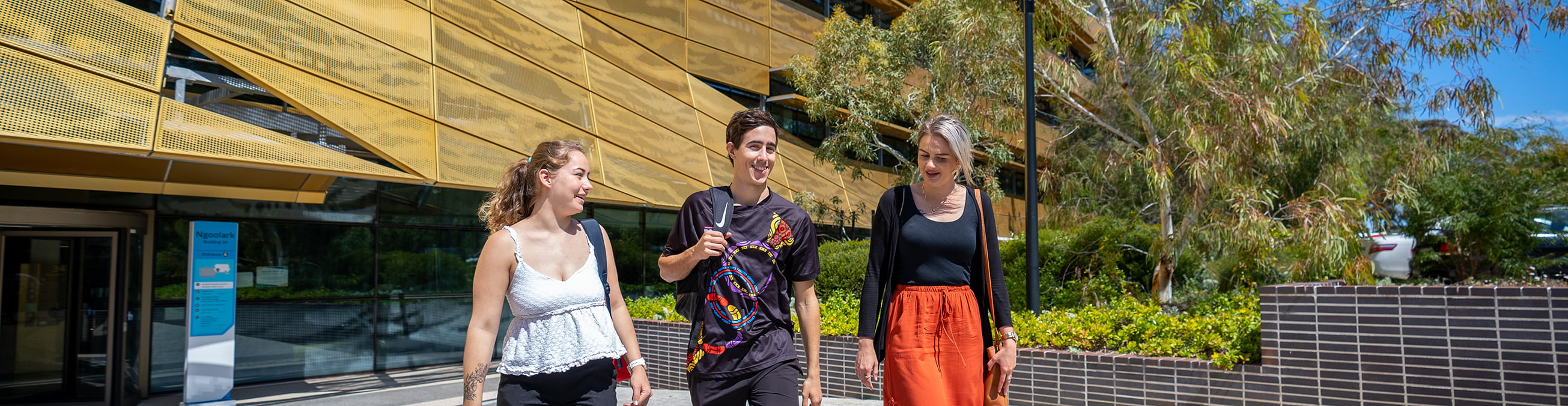 Three students walking down path